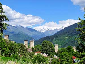 Georgia: Defence towers and Caucasus snow mountains before Mestia in Svaneti