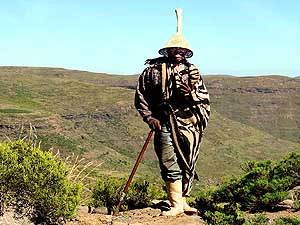Lesotho/Blue Mountain Pass: Shepherd with typical Basotho hat (Mokorotlo)